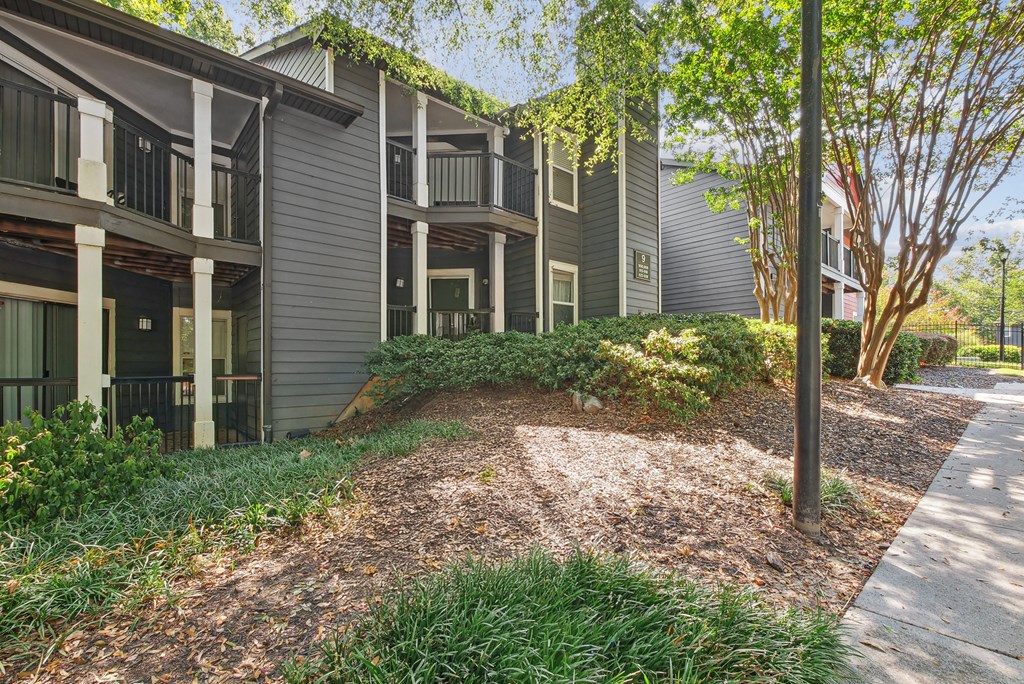 A building with a grey facade and a green tree in front at Elme Druid Hills, Atlanta, Georgia